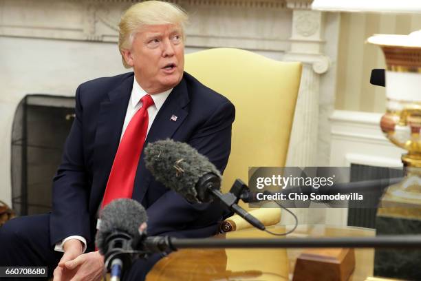 President Donald Trump answers reporters' questions during a photo opportunity with Prime Minister Of Denmark Lars Lokke Rasmussen in the Oval Office...