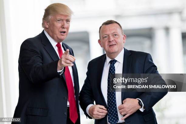 President Donald Trump greets Denmark's Prime Minister Lars Lokke Rasmussen outside the West Wing of the White House before a meeting on March 30,...