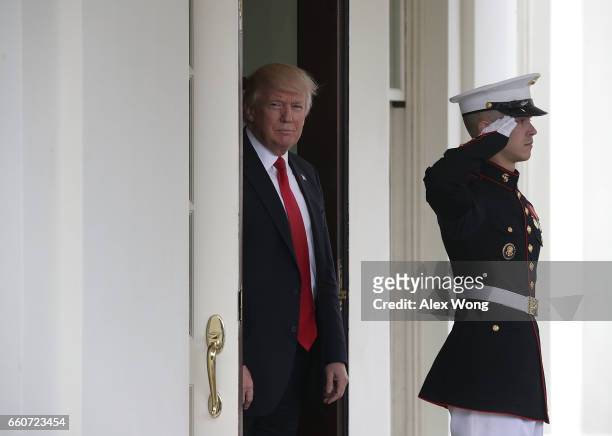 President Donald Trump waits to greet Prime Minister Lokke Rasmussen of Denmark outside the West Wing of the White House March 30, 2017 in...