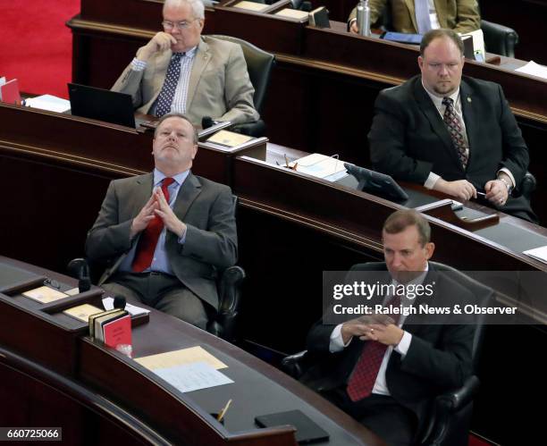 Senate President pro tem Phil Berger , left front, and Sen. Harry Brown , right front, and other senators listen as HB 142 is debated on the Senate...