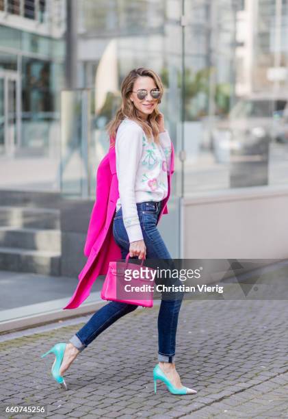 Model and fashion blogger Alexandra Lapp wearing a cashmere pullover from Heartbreaker with precious details of sewed on colorful pastel flowers,...
