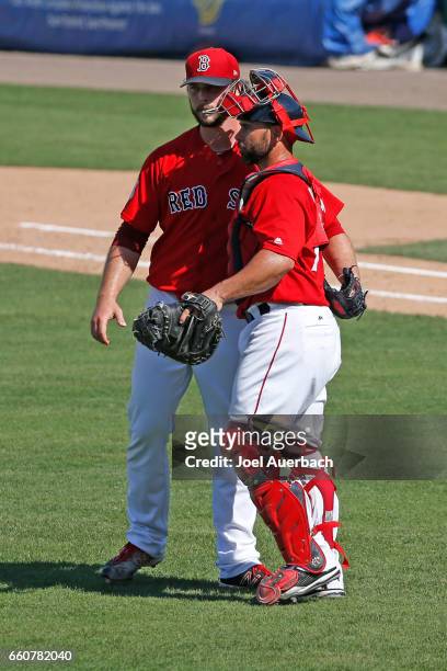 Dan Butler congratulates Ben Taylor of the Boston Red Sox after the final out against the Washington Nationals in the ninth inning during a spring...
