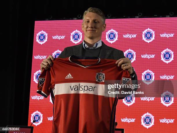 Bastian Schweinsteiger poses with his jersey as the The Chicago Fire Introduce him during a press conference on March 29, 2017 at the The PrivateBank...