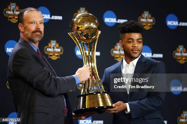 Barry Bedlan, Deputy Director of AP Sports Products at The Associated Press, presents Frank Mason III of the Kansas Jayhawks with the Associated...