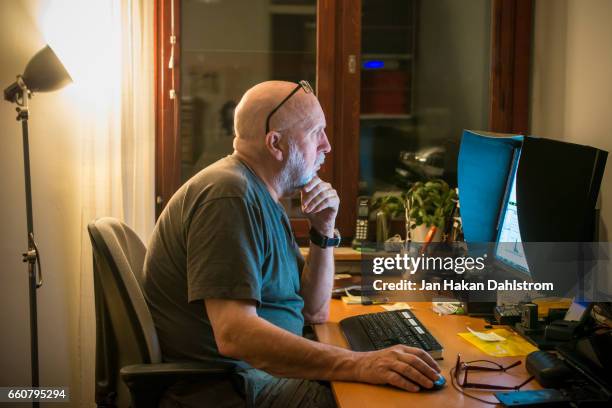 elderly man working from home - hairless mouse stock pictures, royalty-free photos & images
