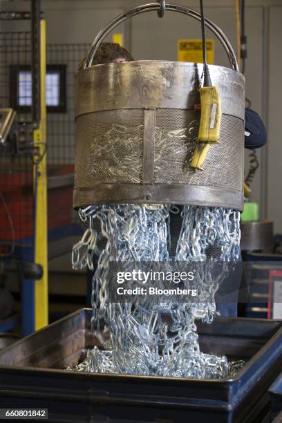 An employee dump chains in a bin for electro zinc plating during production at the Pewag Inc. Manufacturing facility in Pueblo, Colorado, U.S., on...