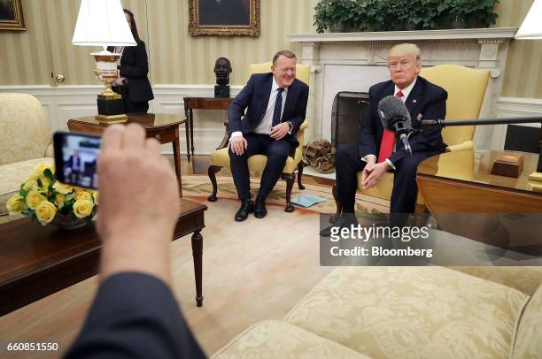 President Donald Trump, right, sits during a meeting with Lars Lokke Rasmussen, Denmark's prime minister, in the Oval Office at the White House in...