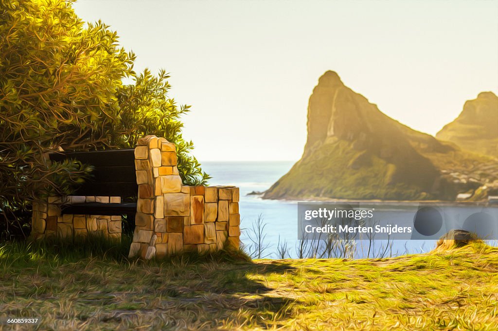 Tranquil overgrown bench with mountain view
