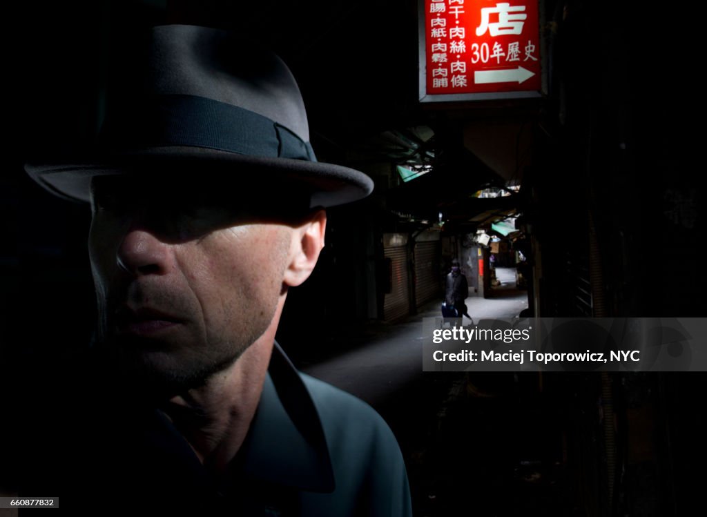 Portrait of a man in hat in Chinatown.