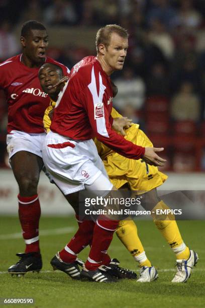 Brighton and Hove Albion's Leon Knight gets sandwiched between Nottingham Forest's Wes Morgan and Jon Olav Hjelde