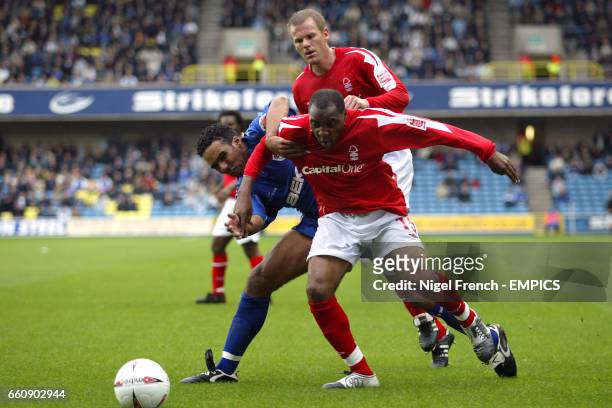 Millwall's Paul Ifill , Nottingham Forest's Andy Impey and Jon Olav Hjelde battle for the ball
