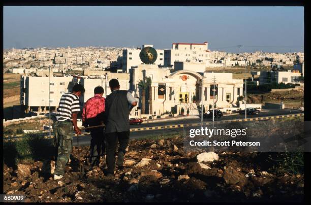 Men plow a field across from the new Hard Rock Cafe restaurant May 17, 1998 in Amman, Jordan. Still a teenager when crowned in 1952, King Hussein has...