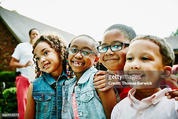 smiling young cousins at family celebration - memorial garden stock pictures, royalty-free photos & images