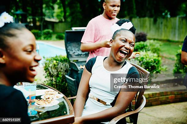 laughing girl at backyard family celebration - fraternity brother stock pictures, royalty-free photos & images