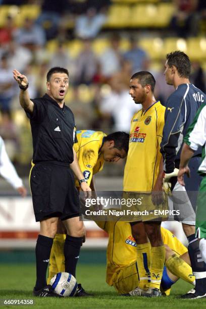 Referee Mark Halsey waves away Hammarby's goalkeeper Ante Covic after he appeals against a free kick