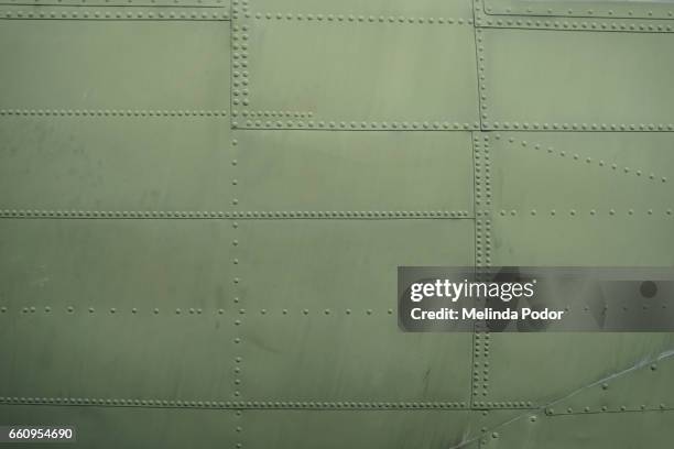 patchwork of riveted metal pieces - flugzeugrumpf stock-fotos und bilder