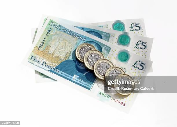 newly printed and minted british currency. - sterling stock pictures, royalty-free photos & images