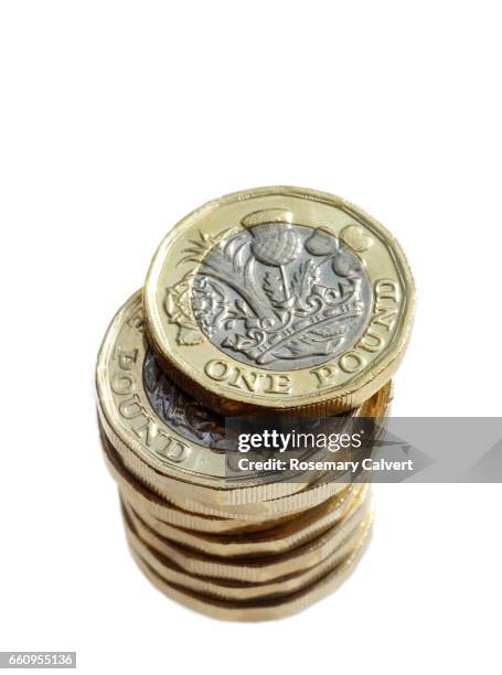 newly minted one pound coins in stack. - one pound coin stock pictures, royalty-free photos & images