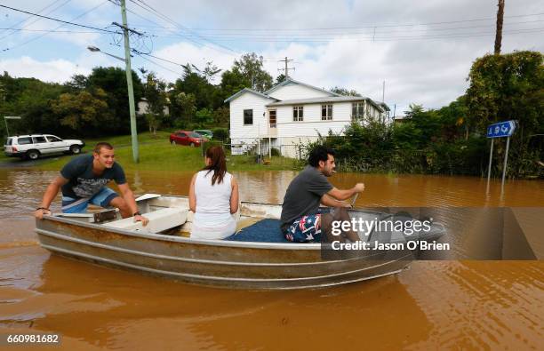 Residents row a boat down a street in South Murwillumbah on March 31, 2017 in Murwillumbah, Australia. Heavy rain has caused flash flooding in south...