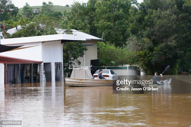 Residents use a boat on March 31, 2017 in South Murwillumbah, Australia. Heavy rain has caused flash flooding in south east Queensland and Northern...