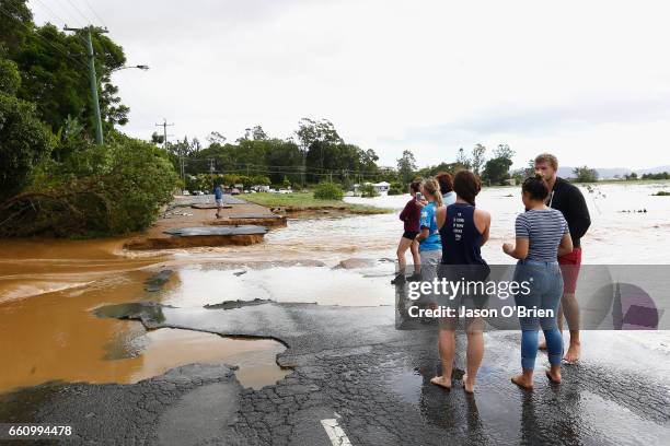 Residents look as as fllod waters destroyed the main road on March 31, 2017 in South Murwillumbah, Australia. Heavy rain has caused flash flooding in...