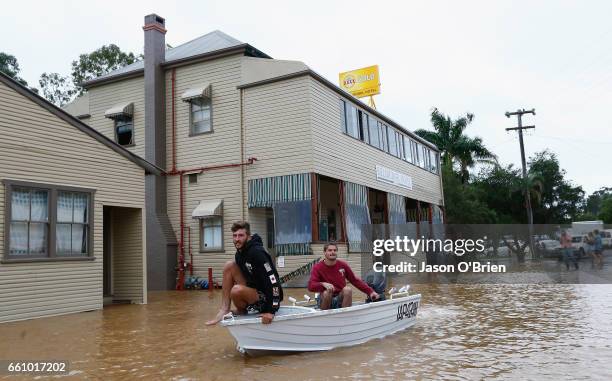 Local residents use a boat in the main street on March 31, 2017 in Billinudgel, Australia. Heavy rain has caused flash flooding in south east...