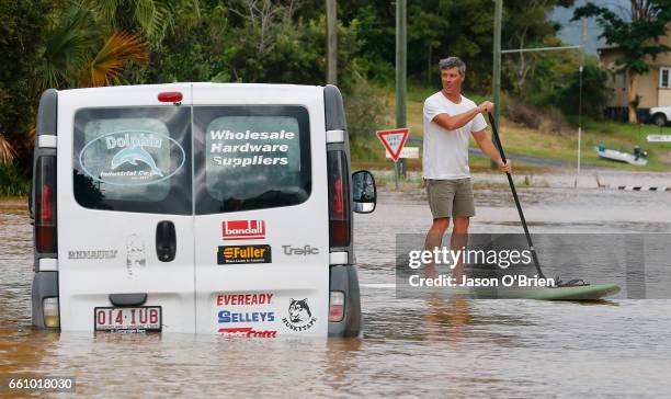 Local residents paddle down the main street on March 31, 2017 in Billinudgel, Australia. Heavy rain has caused flash flooding in south east...