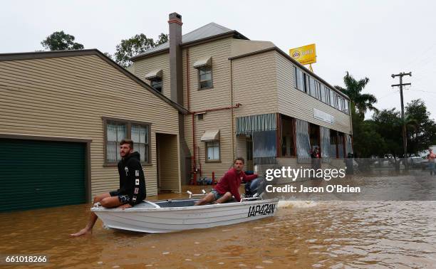 Local residents use a boat in the main street on March 31, 2017 in Billinudgel, Australia. Heavy rain has caused flash flooding in south east...