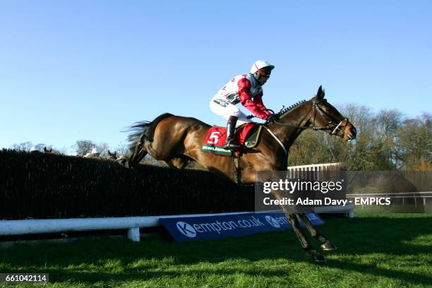 Ollie Magern ridden by Carl Llewellyn jumps the first fence on his way to winning The Stan James Feltham Novices' Steeple Chase