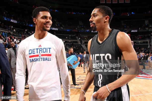 Michael Gbinije of the Detroit Pistons talks with Spencer Dinwiddie of the Brooklyn Nets after the game on March 30, 2017 at The Palace of Auburn...