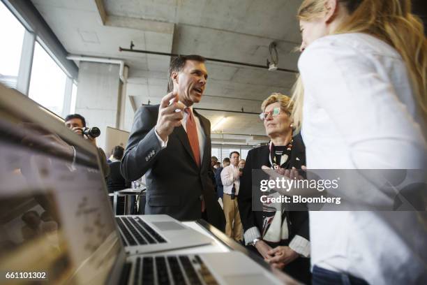 Bill Morneau, Canada's finance minister, center left, speaks as Kathleen Wynne, premier of Ontario, center right, looks on during a demonstration at...