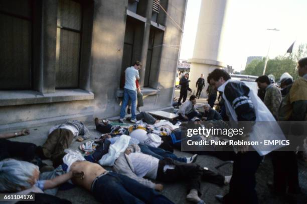 The bodies of some of the 39 Juventus fans who died in the Heysel Stadium disaster are laid outside the ground