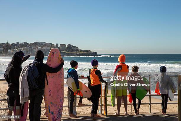 young surfers bondi beach - bondi beach stock pictures, royalty-free photos & images