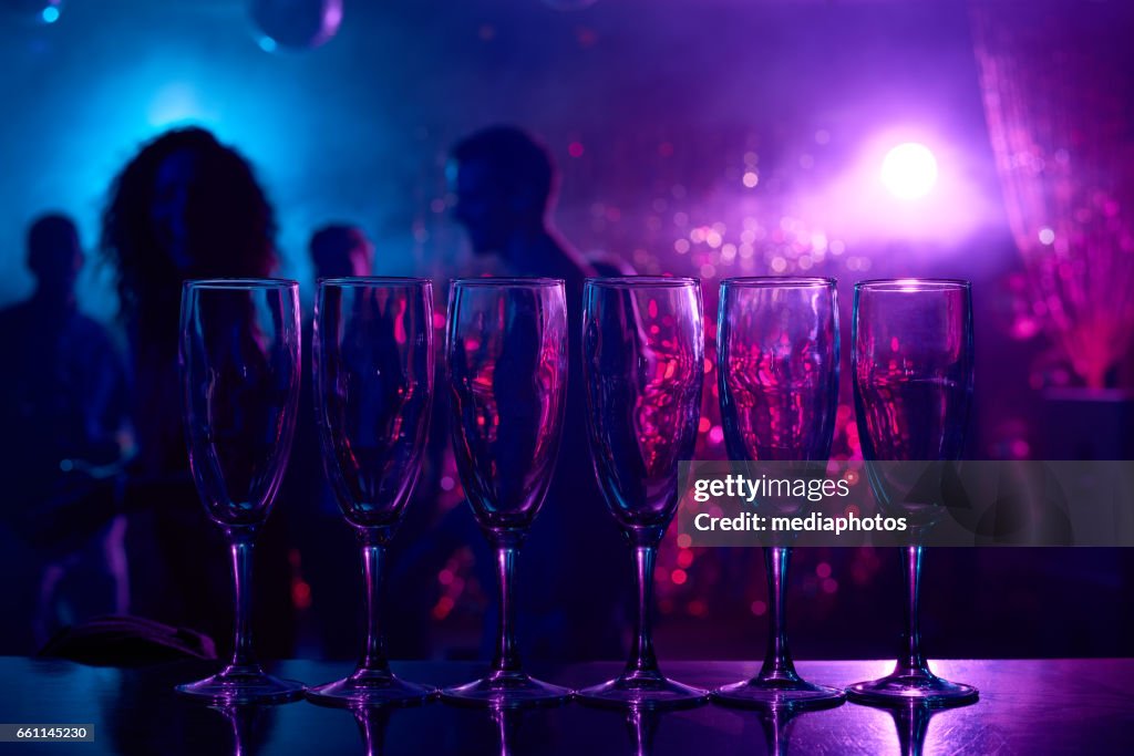 Champagne flutes on bar counter