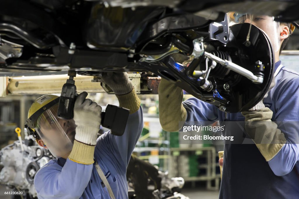 Subaru Assembly Line Workers assemble a Subaru branded vehicle on the production line of ...