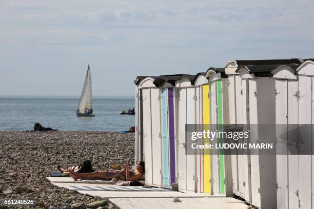 People enjoy a sunny day on the beach of Le Havre, on the Normandy coast on March 30, 2017.