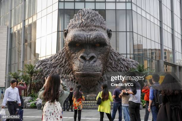 Citizens look at a giant King Kong statue at TaiKoo Hui on March 30, 2017 in Guangzhou, Guangdong Province of China. The five-metre-tall King Kong...
