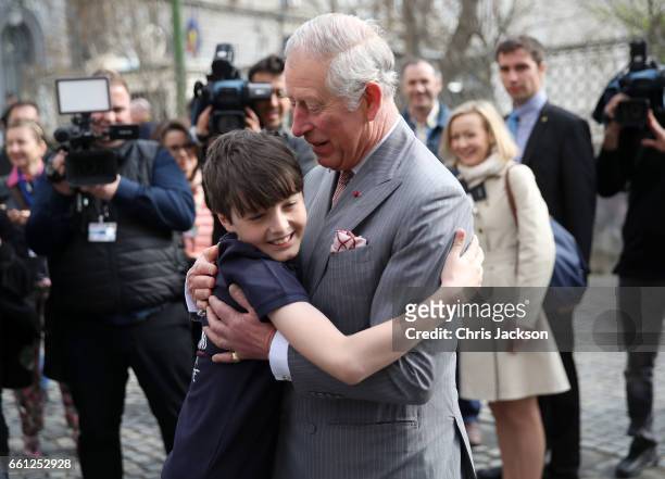Prince Charles, Prince of Wales receives a hug from Valentin Blacker, son of William Blacker who is a local conservationist during a walking tour of...