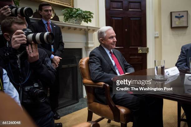 Attorney General Jeff Sessions listens as President Donald Trump speaks during a meeting with the Fraternal Order of Police in the Roosevelt Room of...