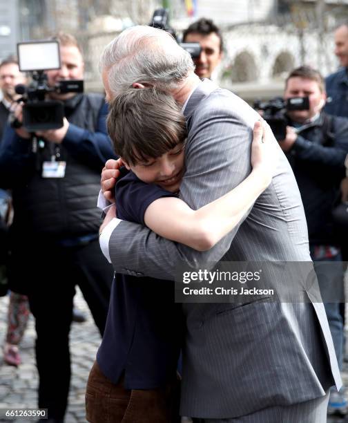 Prince Charles, Prince of Wales receives a hug from Valentin Blacker, son of William Blacker who is a local conservationist during a walking tour of...