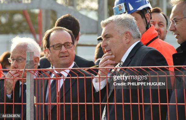 French President Francois Hollande speaks with Boulogne-sur-Mer Mayor and MP Frederic Cuvillier during a visit of a construction site at the National...