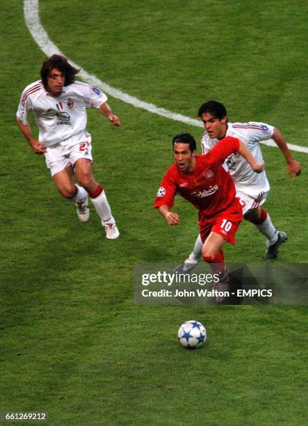 Liverpool's Luis Garcia wins the ball from AC Milan's Andrea Pirlo and Kaka