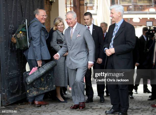 Prince Charles, Prince of Wales shares a joke with passersby during a walking tour of the Old Town on the third day of his nine day European tour on...