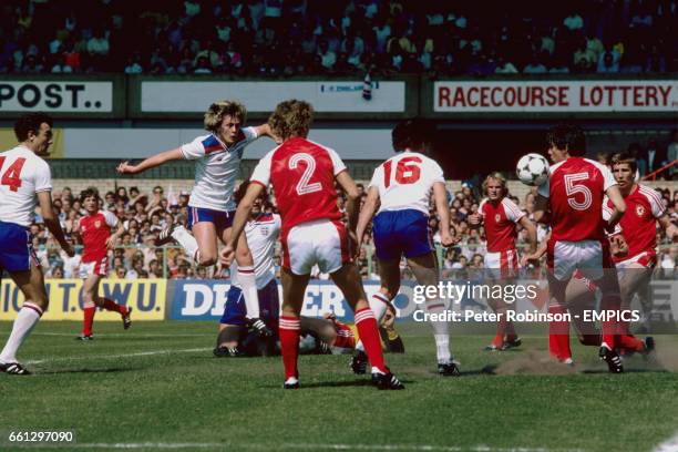 England's Paul Mariner deflects a shot from teammate Peter Barnes into the Wales net, via the shoulder of Wales's David Jones , for England's only...