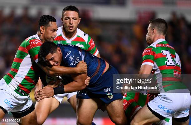 Jason Taumalolo of the Cowboys is tackled by John Sutton of the Rabbitohs during the round five NRL match between the North Queensland Cowboys and...
