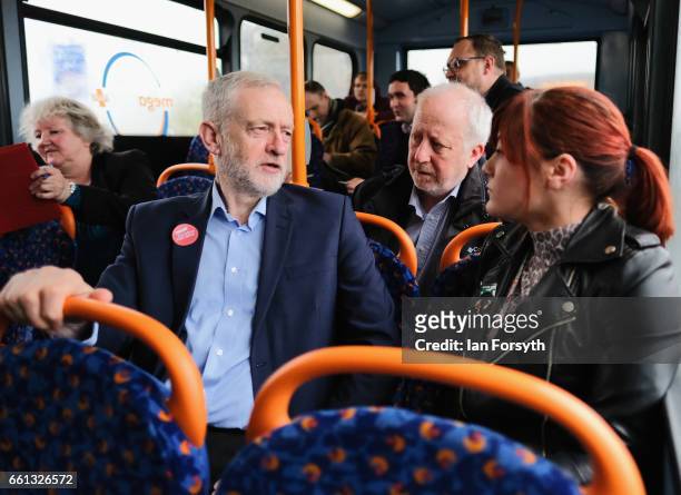 Labour leader Jeremy Corbyn speaks to fellow passengers as he takes a ride on the number 36 bus from Middlesbrough to Stockton on Tees on March 31,...