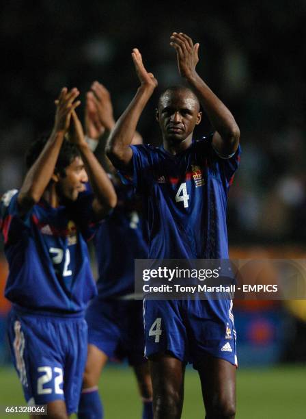 France's Patrick Vieira and Vikash Dhorasoo applaud the fans at the end of the match