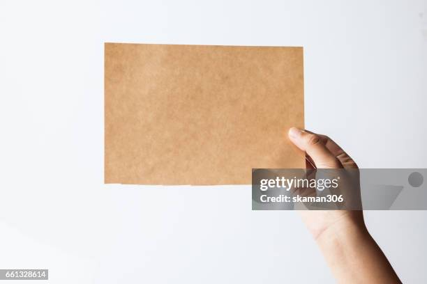 female  hand hold  blank paper isolated white background - person holding blank piece of paper stock pictures, royalty-free photos & images