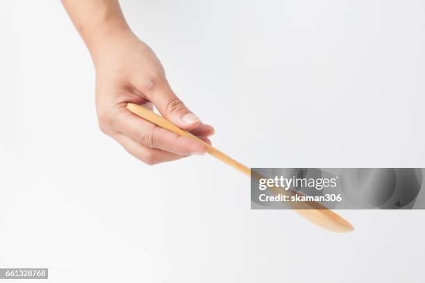 female hands hold wooden spoon  for cooking - spoon in hand stock-fotos und bilder