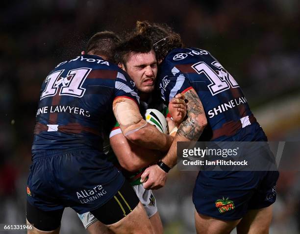 Angus Crichton of the Rabbitohs is tackled by Gavin Cooper and Ethan Lowe of the Cowboys during the round five NRL match between the North Queensland...